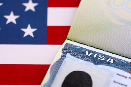 VISA to the USA and the flag of the United States of America. Work and travel documents for visiting the USA. Visa for immigrationの写真素材