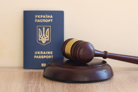Judge hammer and ukrainian passport on brown background. Passport Of Ukraine.の写真素材
