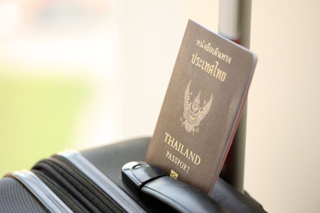 Thai passport on travel luggage close up. The concept of travel and vacationの写真素材