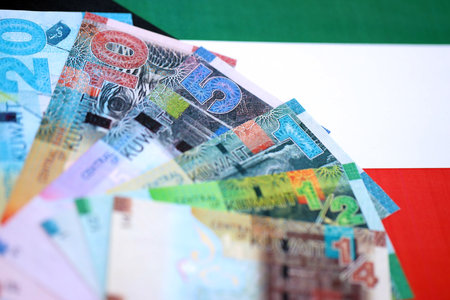 Kuwaiti dinar currency money bills lies on flag close up. The concept of business and investmentの写真素材