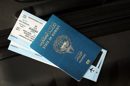 Kuwaiti passport and avia tickets on travel bag close up. The concept of travel and vacationの写真素材