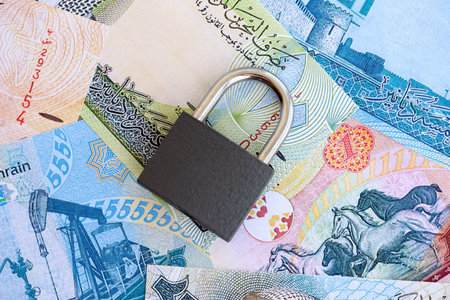 Bahraini dinar currency money bills and padlock close up. The concept of sanctions and financial safetyの写真素材