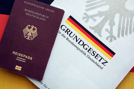 The constitution basic law book of Germany and passport lies on Germany flag background close upの写真素材