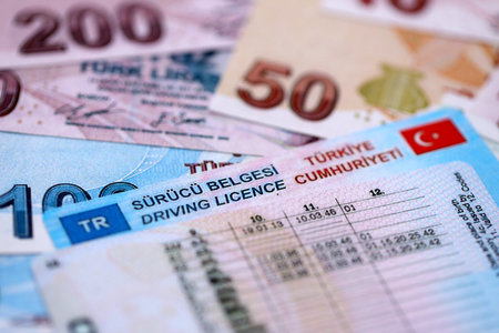 Turkiye driving permit concept. Driver license and turkish liras money bills close upの写真素材