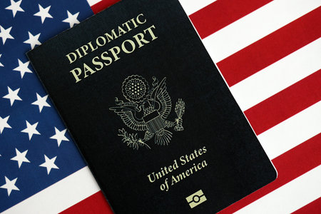 United States diplomatic passport book on US flag close up. Travel document on official banner photoの写真素材