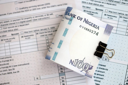 Nigerian naira money bills on tax form close up. Taxation and accounting concept