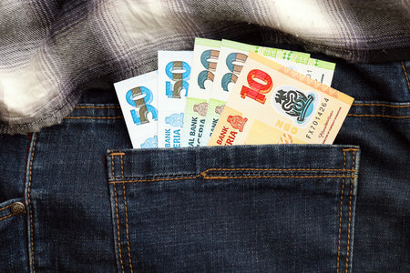 Nigerian naira money bills in denims pocket close up. The concept of fashion and wealth