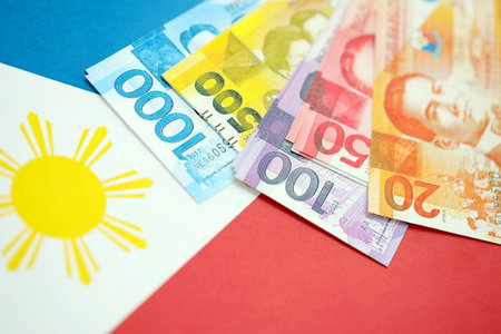 Philippines peso currency money bills lies on flag close up. The concept of business and investmentの写真素材