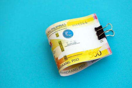 Philippines peso money bills in big amount close up on blue. Finance and banking conceptの写真素材