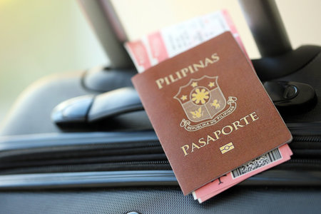 Philippines passport and avia tickets on travel bag close up. The concept of travel and vacationの写真素材
