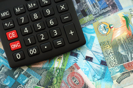 Kuwaiti dinar currency money bills and calculator close up. The concept of taxation and money countの写真素材