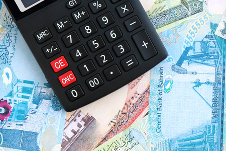 Bahraini dinar currency money bills and calculator close up. The concept of taxation and money count
