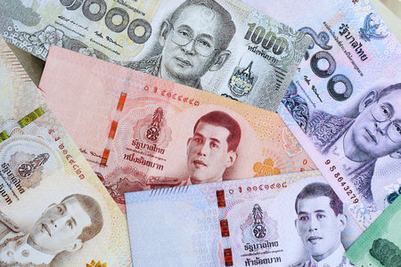 Thai baht currency money bills. The current banknotes lies on table in big amount close up
