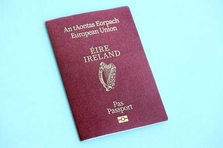 Ireland passport on light blue paper background close up. Citizenship and travel in Europe conceptの写真素材