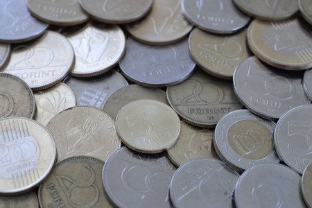 Many Hungarian forint coins in big stack close up. Forint is an official Hungarian currency instead...