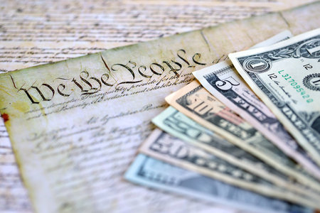 American US dollars money bills and constitution close up on old pages