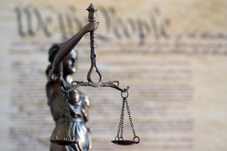 The statue of justice Themis, the blindfolded goddess of justice against US Constitution page. Judgement and punishment in United Statesの写真素材