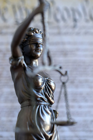 The statue of justice Themis, the blindfolded goddess of justice against US Constitution page. Judgement and punishment in United Statesの写真素材