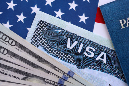VISA on a background of U.S. flag and US dollars. travel or immigration concept close up
