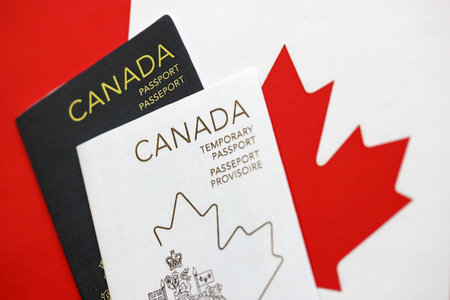 Canadian temporary and permanent passports lies on flag close upの写真素材