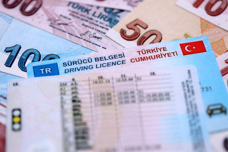 Turkiye driving permit concept. Driver license and turkish liras money bills close upの写真素材