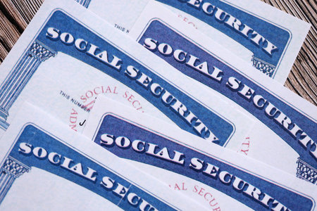Social security number cards on brown wooden background surface close upの写真素材