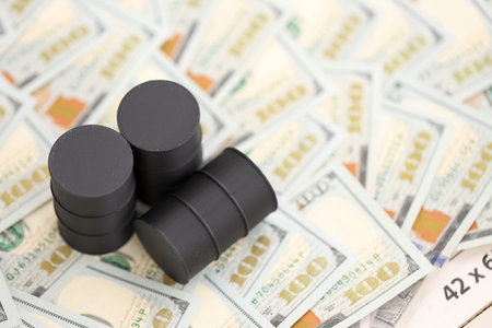 Barrels of oil on bills of American dollars. purchase, sale of oil concept close up