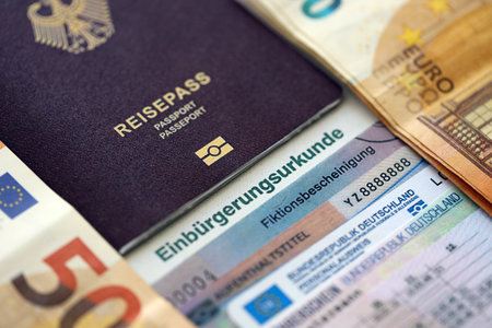 German passport and an identity card on an official naturalization certificate. Symbolic for successful acquisition of German citizenship close upの写真素材
