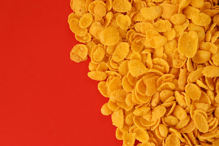 Background of breakfast cereals in big amount on red background close up, top viewの写真素材