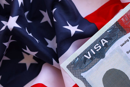 United States flag and United States visa. Concept of Immigration and Travel to the United States. Visa in the passport on the background of the American flagの写真素材