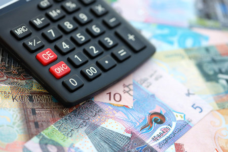 Kuwaiti dinar currency money bills and calculator close up. The concept of taxation and money count