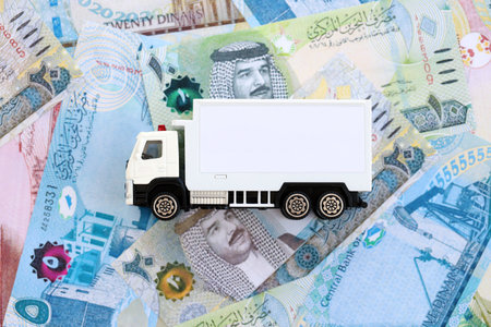 Bahraini dinar currency money bills and toy delivery truck close up. The concept of delivery and...