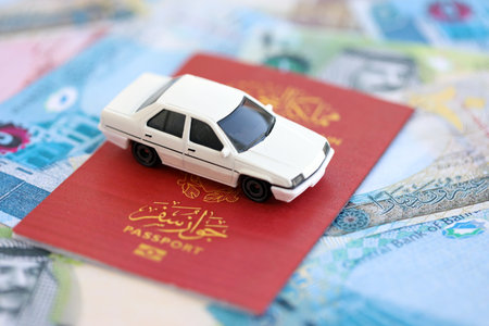 Bahraini dinar currency money bills and car with passport close up. The concept of car ownership