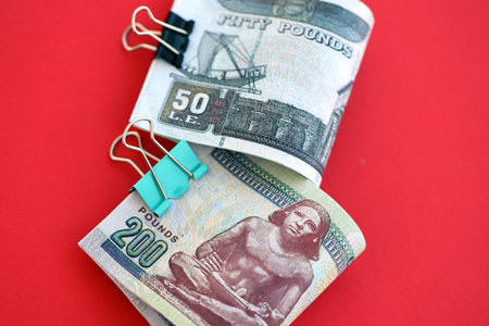 Egyptian pound money bills in big amount on red close up. Finance and banking concept