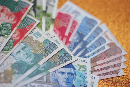 Pakistan rupees banknotes on golden yellow background. The current Pakistan money bills lies on...
