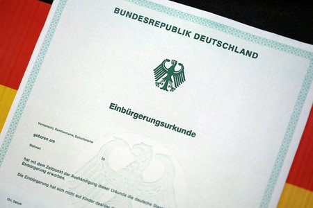 German official naturalization certificate. Symbolic for successful acquisition of German citizenship close upの写真素材