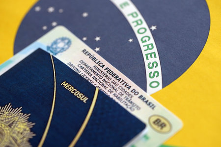 Brazil National Drivers License for a motor vehicle with passport on Brazilian flag close upの写真素材