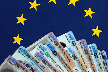 Permanent resident or residence permit cards lies on European Union flag. Specimen cards close upの写真素材
