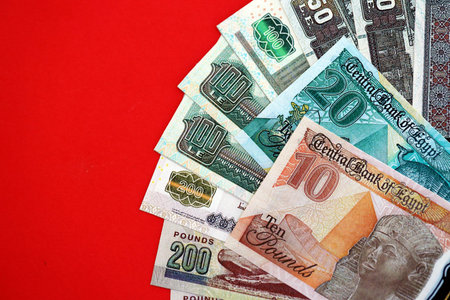 Egyptian pound money bills in big amount on red close up. Finance and banking conceptの写真素材