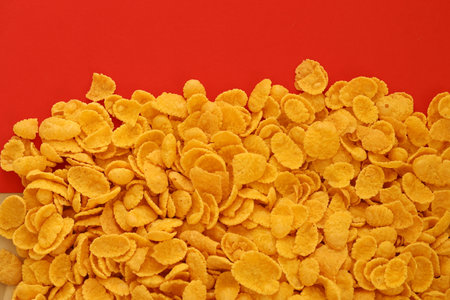 Background of breakfast cereals in big amount on red background close up, top viewの写真素材