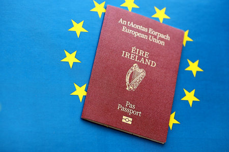Ireland passport on European union blue flag background close up. Citizenship in countries of Europe conceptの写真素材