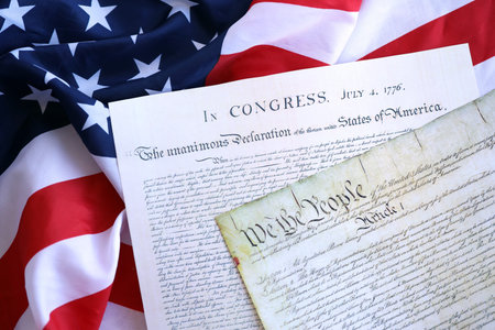 Constitution of the USA with US flag. Aged historical documents Washington DC on American...