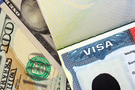 Close up of passport cover with american visa page and hundred dollars as travel backgroundの写真素材