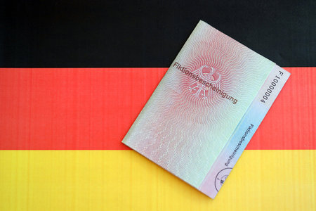German temporary Permanent resident card specimen lies on Germany flag close up. Fiktionsbescheinigungの写真素材