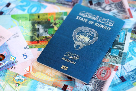 Kuwaiti dinar currency money bills and passport close up. The concept of travel and vacationの写真素材