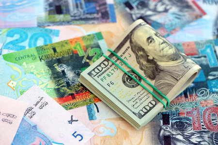Kuwaiti dinar currency money bills and bunch of us dollar banknotes close up. The concept of economics and currency exchangeの写真素材