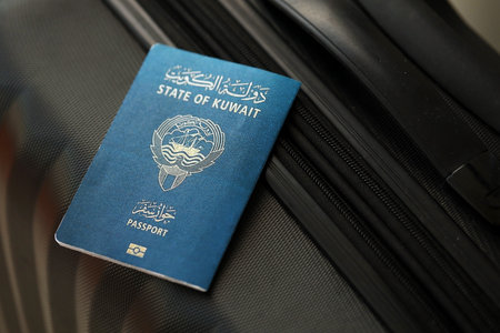 Kuwaiti passport on travel luggage close up. The concept of travel and vacationの写真素材