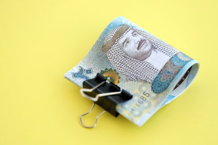 Bahraini dinar money bills in big amount on yellow close up. Finance and banking concept