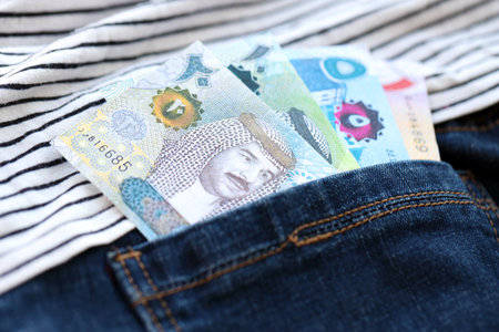 Bahraini dinar money bills in denims pocket close up. The concept of fashion and wealth