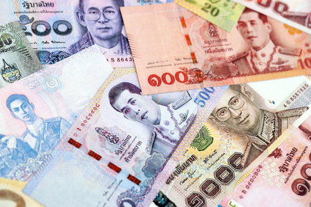 Thai baht currency money. The current banknotes lies on table in big amount close up